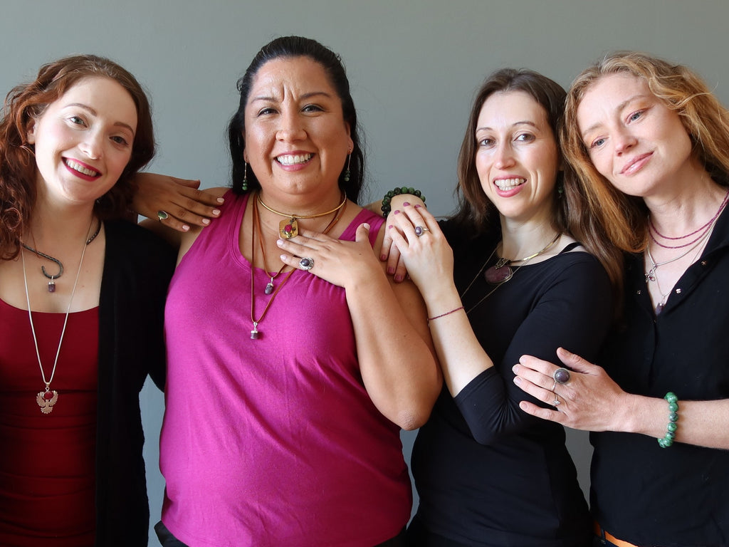 four women wearing ruby jewelry