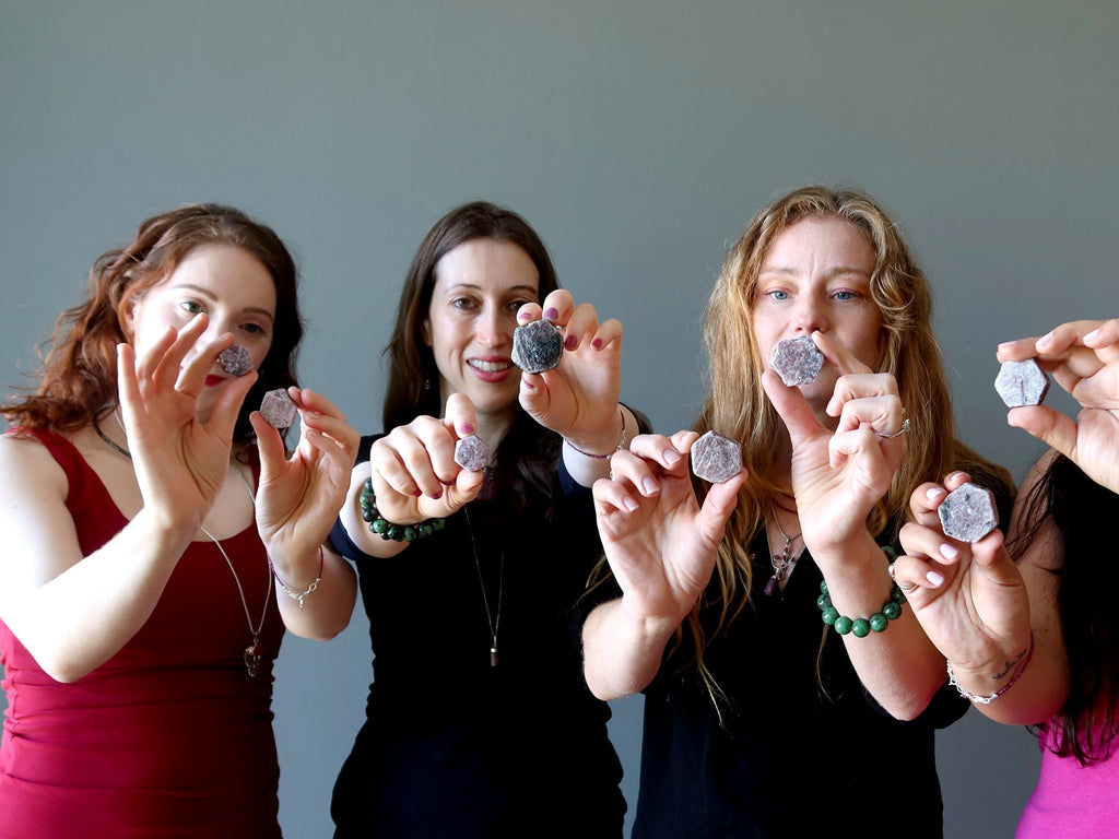 women holding rough ruby hexagons