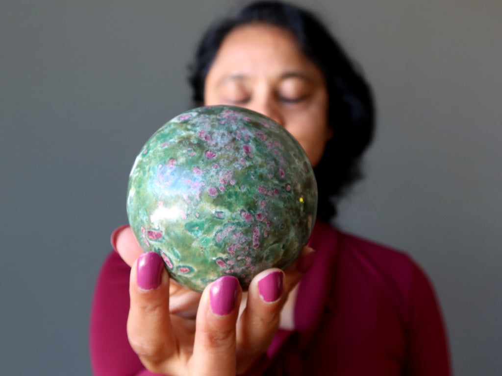 sheila of satin crystals meditating with ruby fuchsite sphere