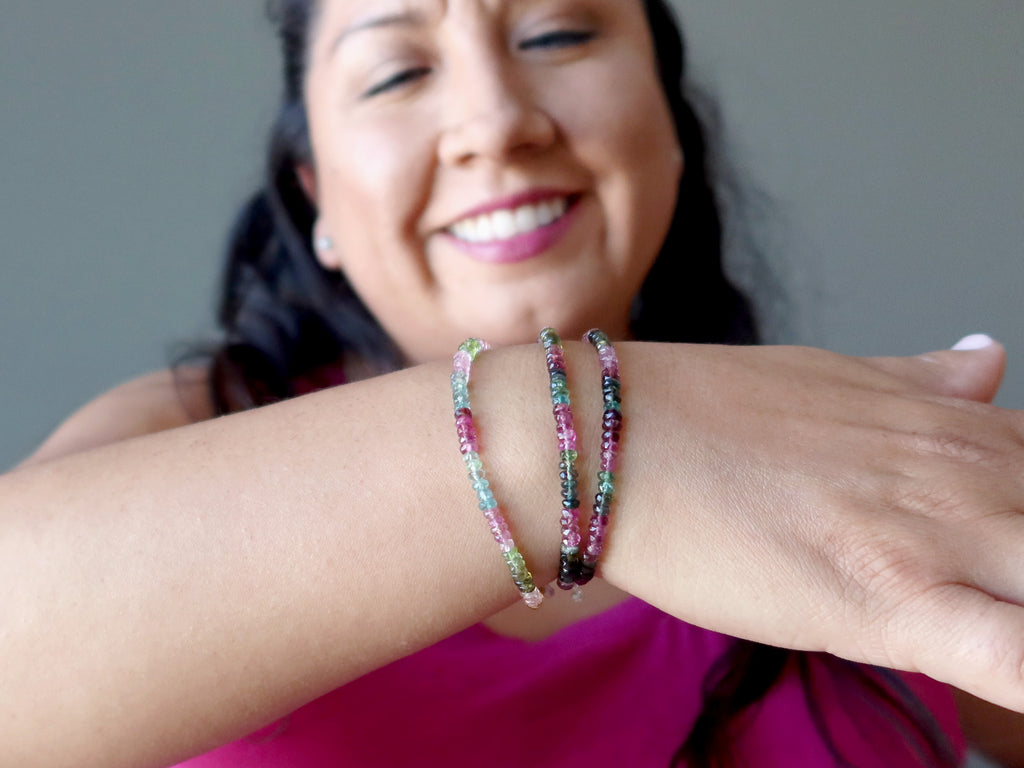 woman wearing faceted rainbow tourmaline bracelets