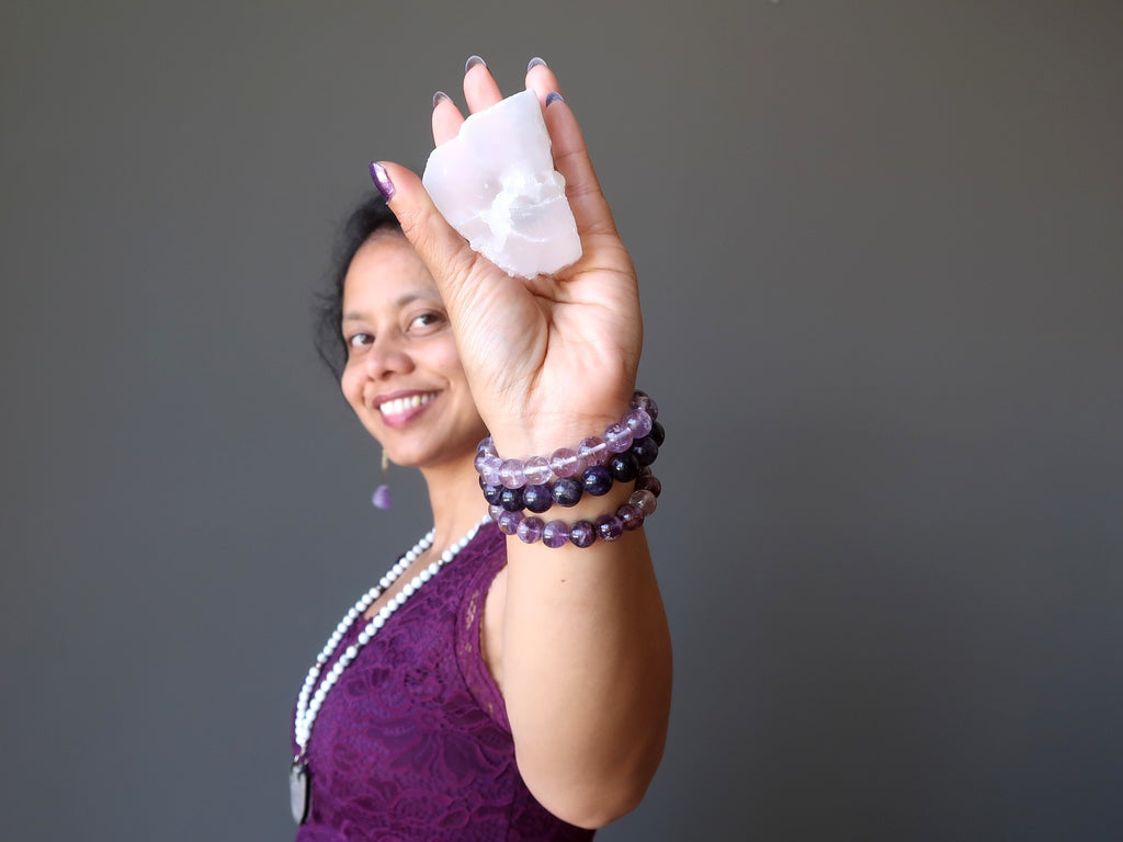 sheila of satin crystals holding a white selenite slab