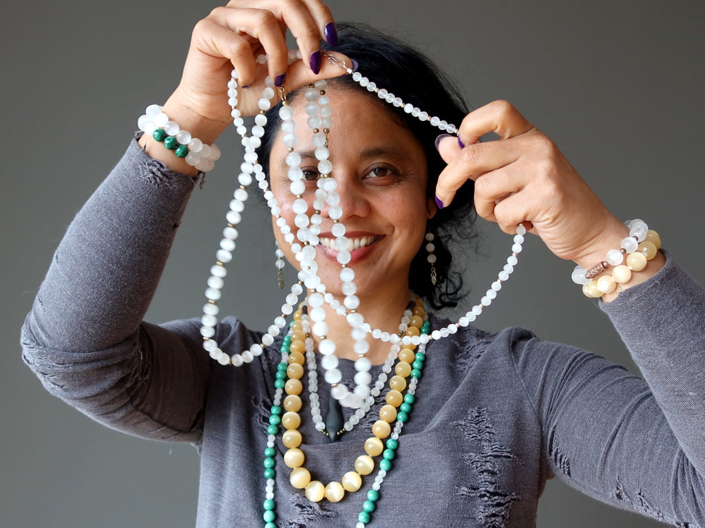 sheila of satin crystals wearing selenite necklaces and bracelets and earrings