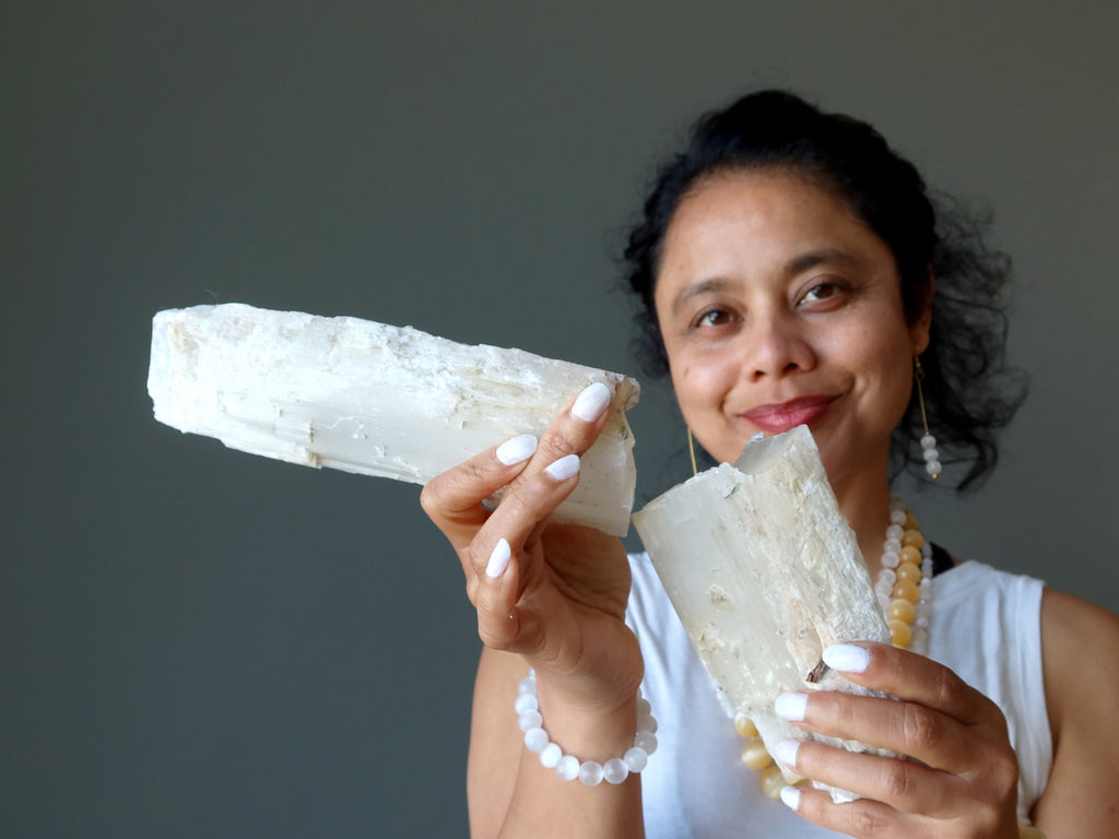 woman holding broken selenite log