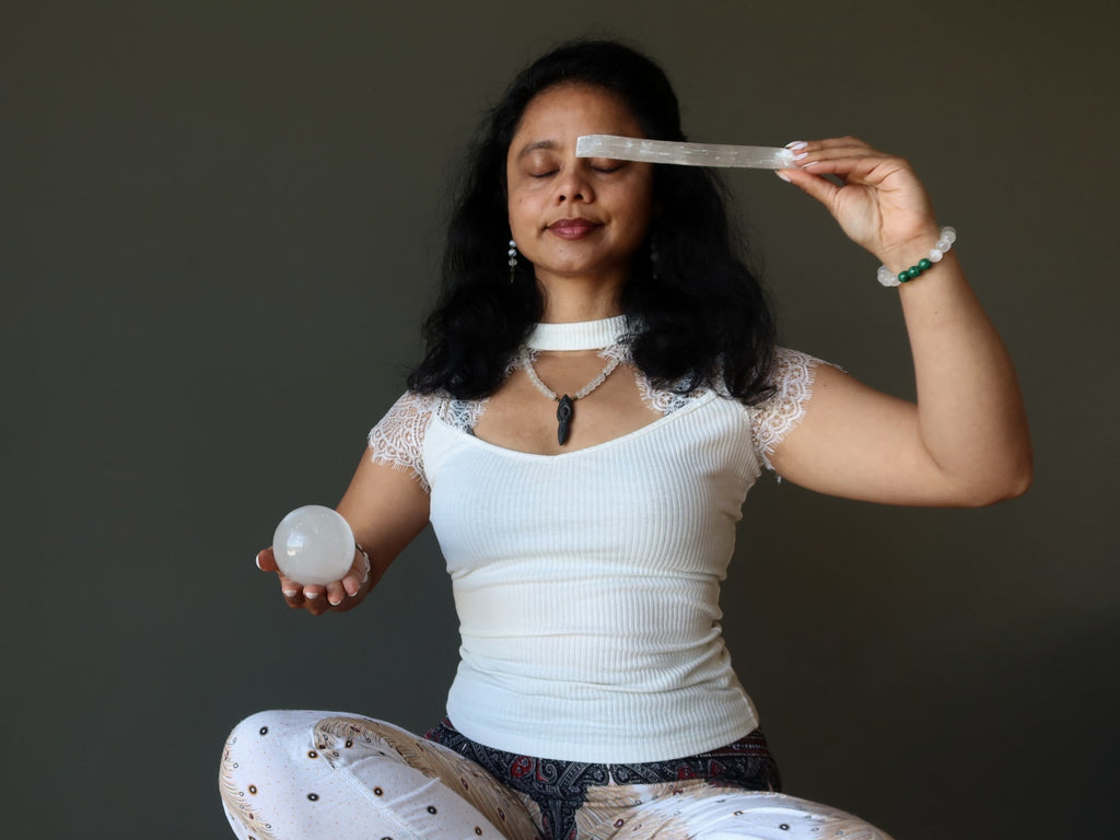 sheila of satin crystals meditating with selenite wand and sphere