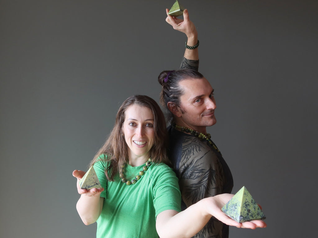 man and woman holding serpentine pyramids