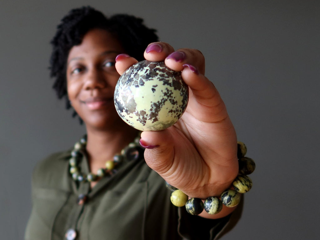 woman holding serpentine pyrite sphere