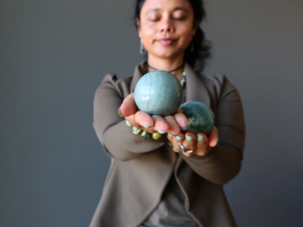 lady holding serpentine spheres