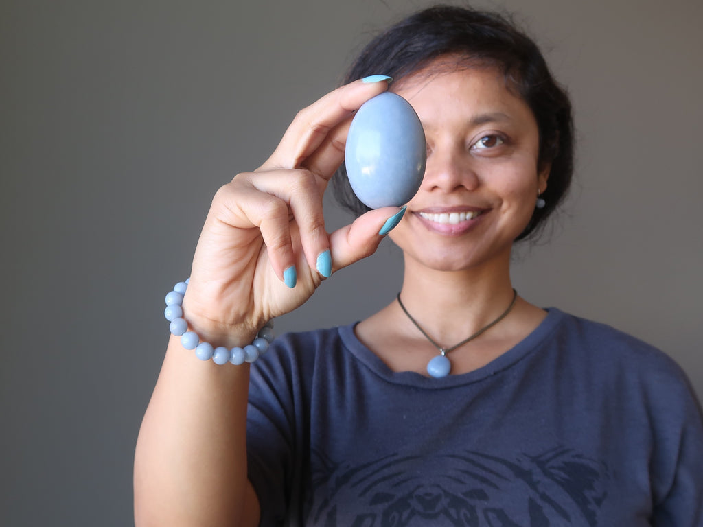 sheila of satin crystals holding an angelite stone egg for shop by intentions page