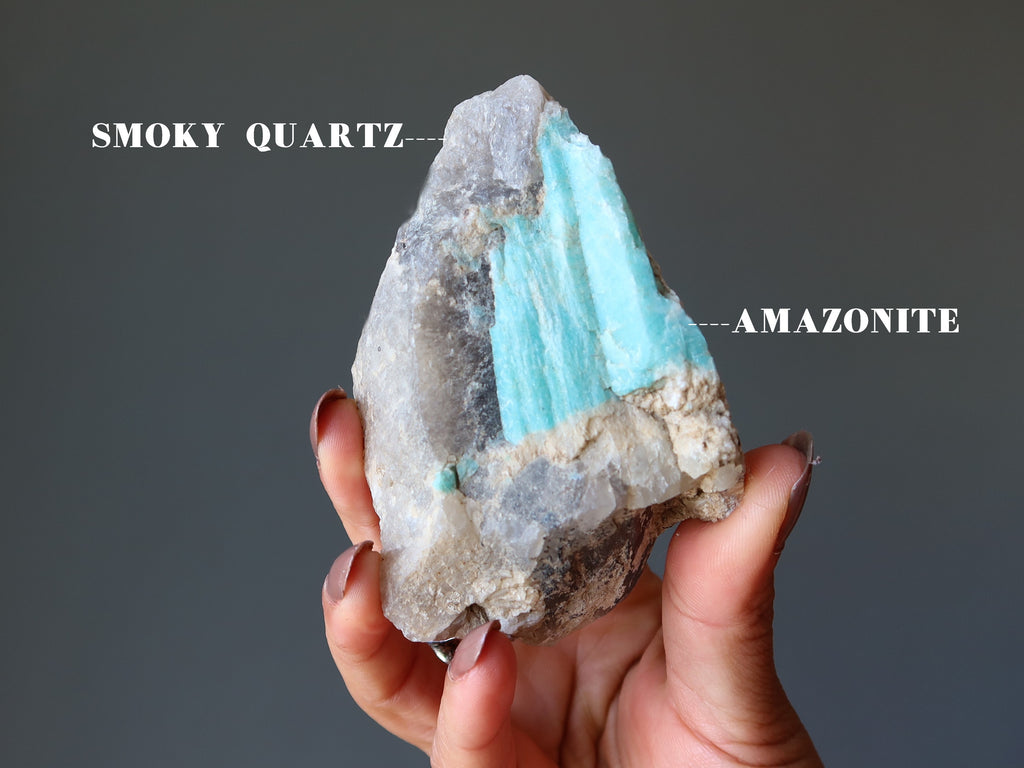 hand holding smoky quartz amazonite cluster