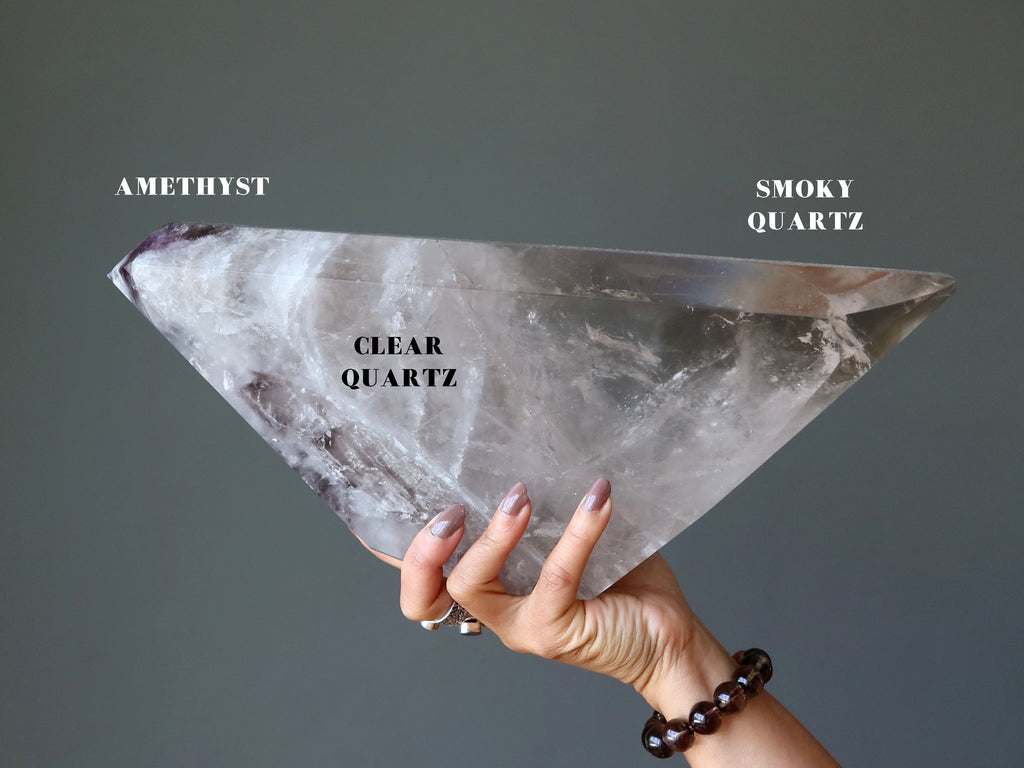 hand holding smoky quartz polygon