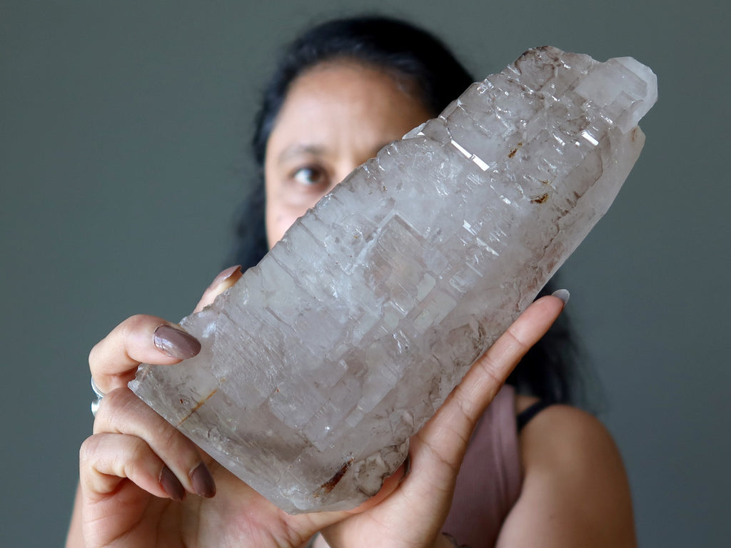 sheila of satin crystals holding raw smoky quartz stone