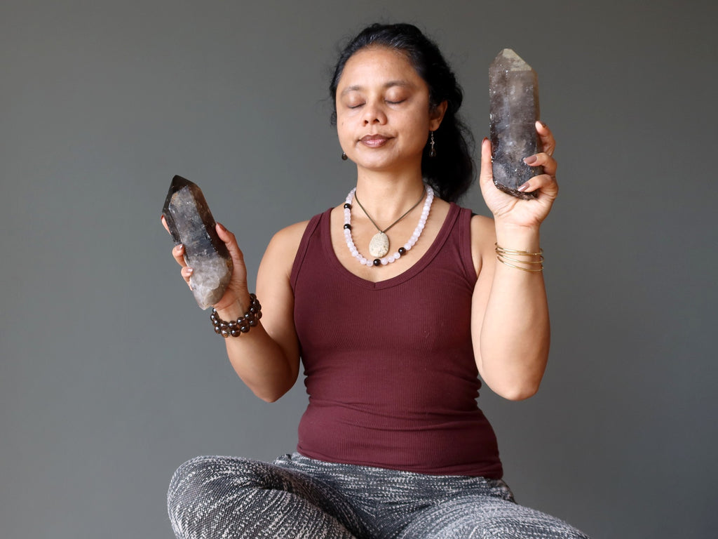 woman meditating with smoky quartz crystals