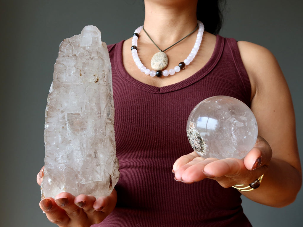 woman holding smoky quartz sphere and raw crystal