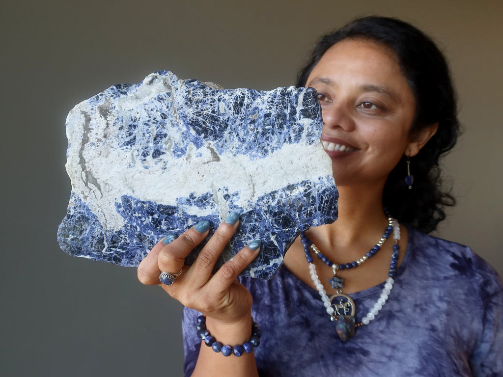 sheila of satin crystals holding sodalite slab