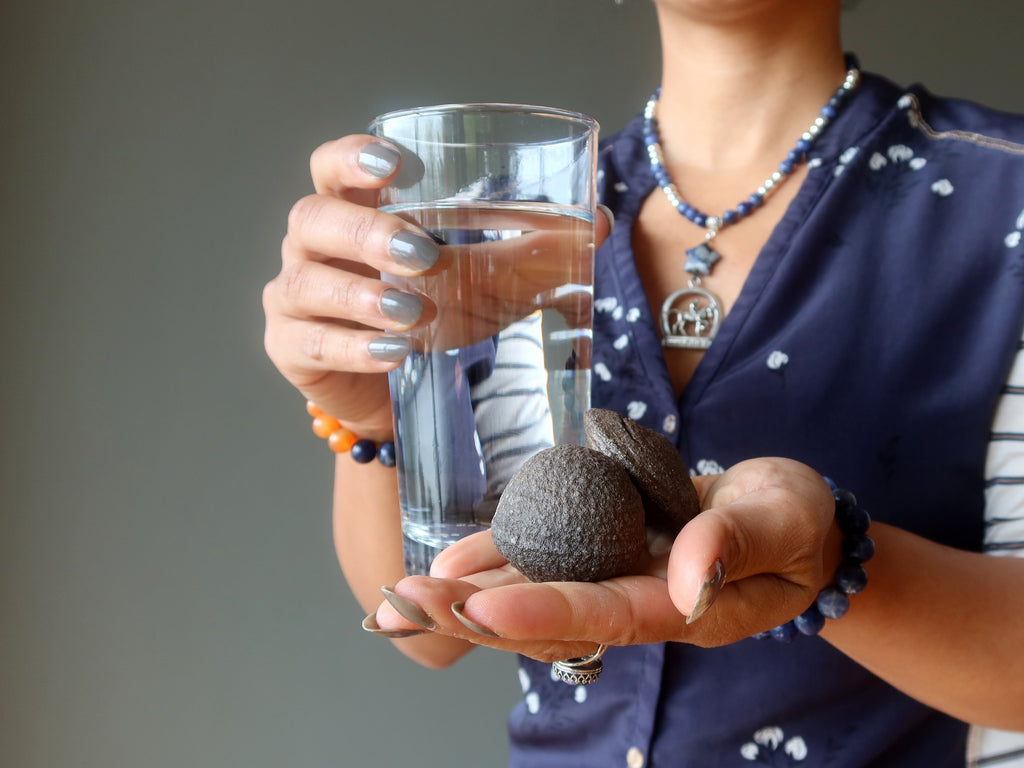 water glass and moqui marble pair in hands