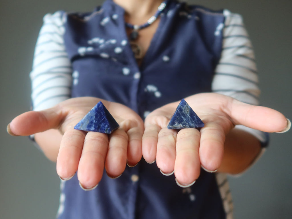 sodalite pyramids in palms of hands