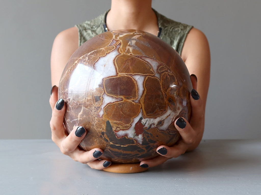 woman's hands holding xl jasper sphere