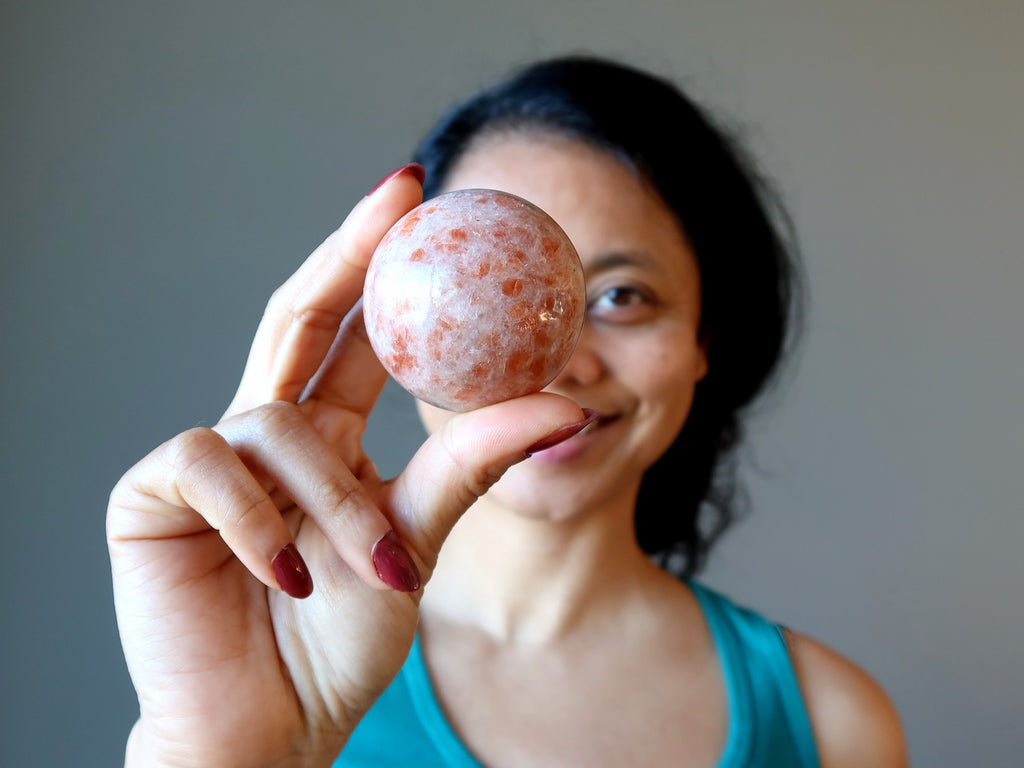 sheila of satin crystals holding sunstone sphere