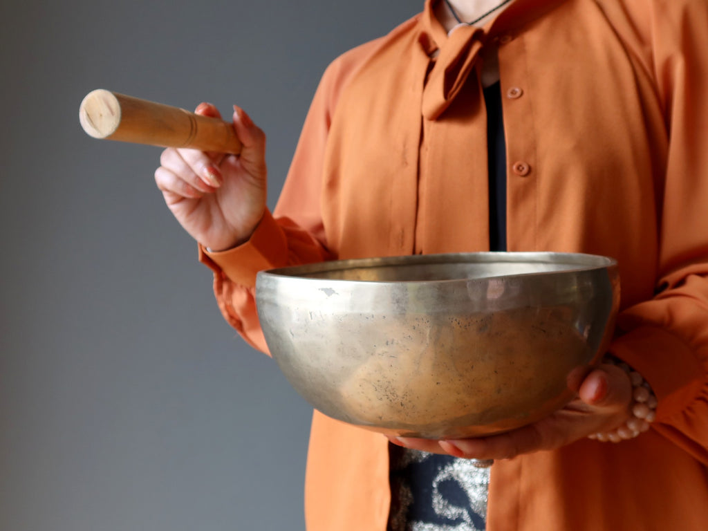 woman playing tibetan singing bowl