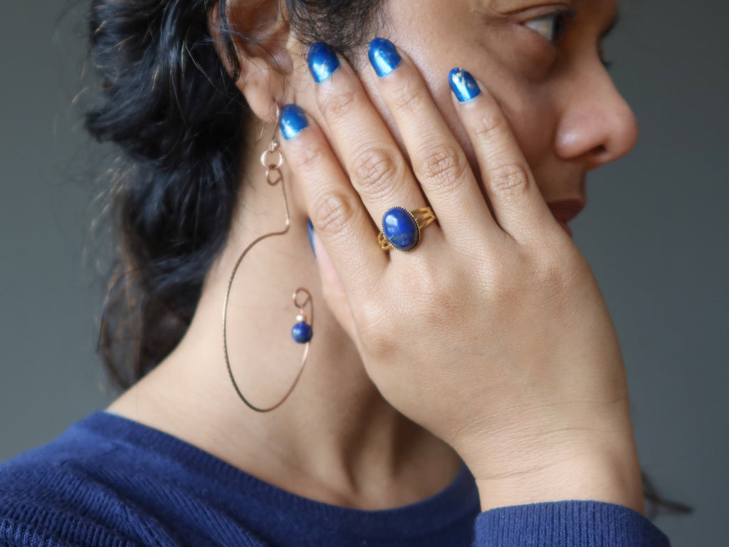 woman wearing lapis ring and earrings