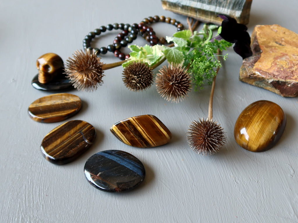 a selection of tigers eye stones and greenery