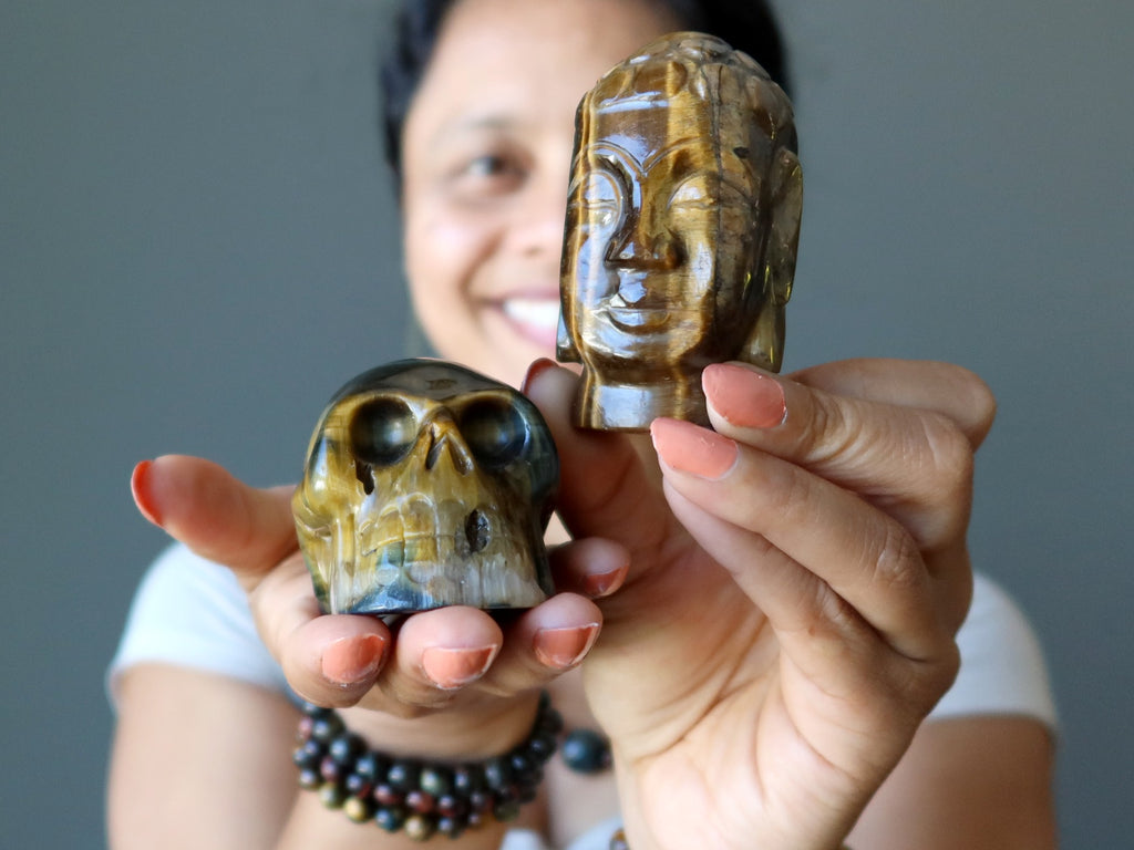 sheila of satin crystals holding a tigers eye skull and buddha head