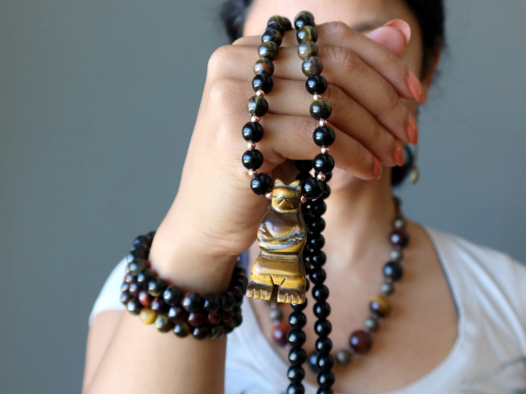 sheila of satin crystals holding a tigers eye bear necklace