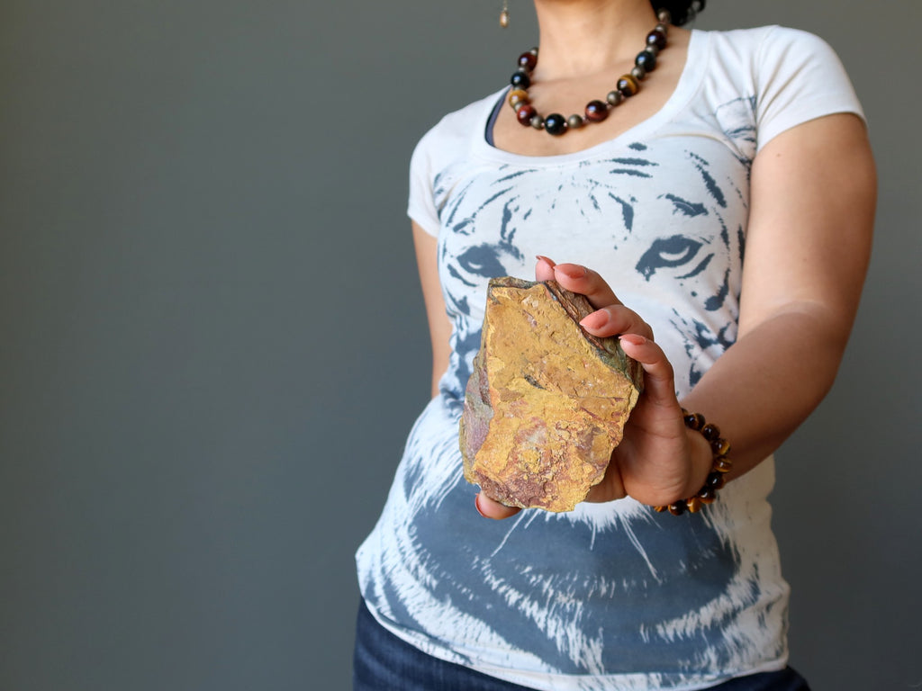 sheila of satin crystals holding a tigers eye stone in front of her tiger tshirt