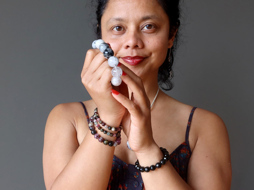 sheila of satin crystals holding and wearing tourmaline bracelets