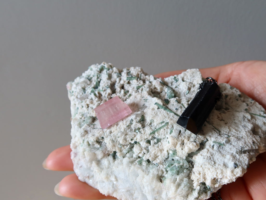 green tourmaline cluster with pink and black tourmaline