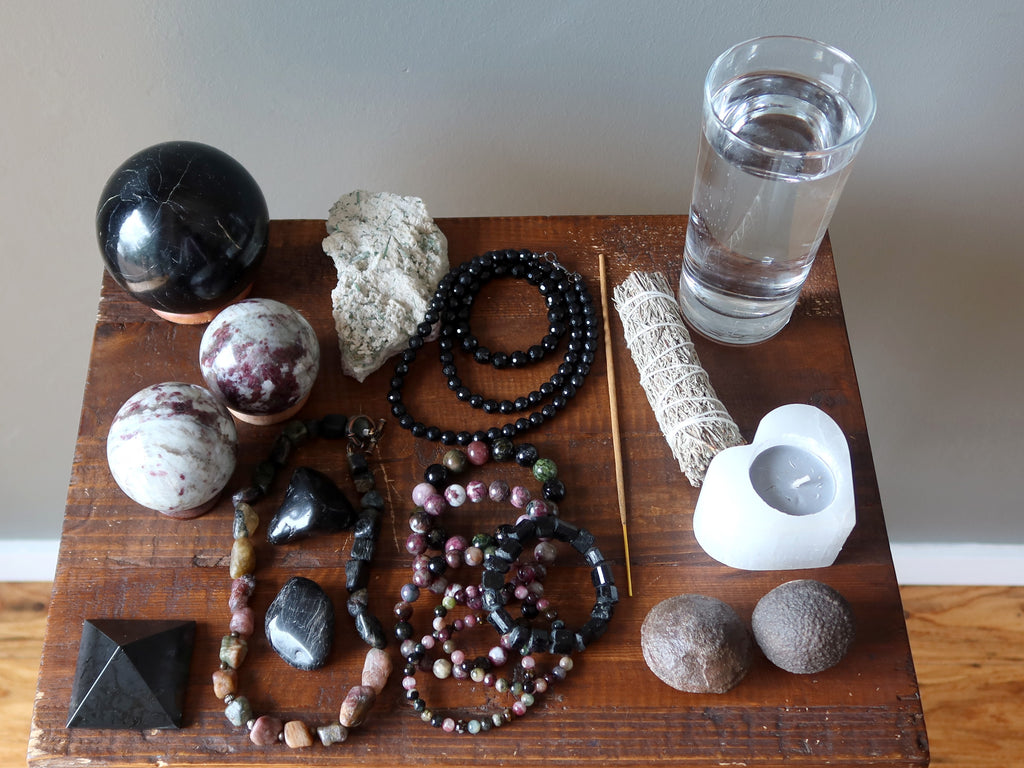 tourmaline, sage, candle, moqui marbles, water for meditation