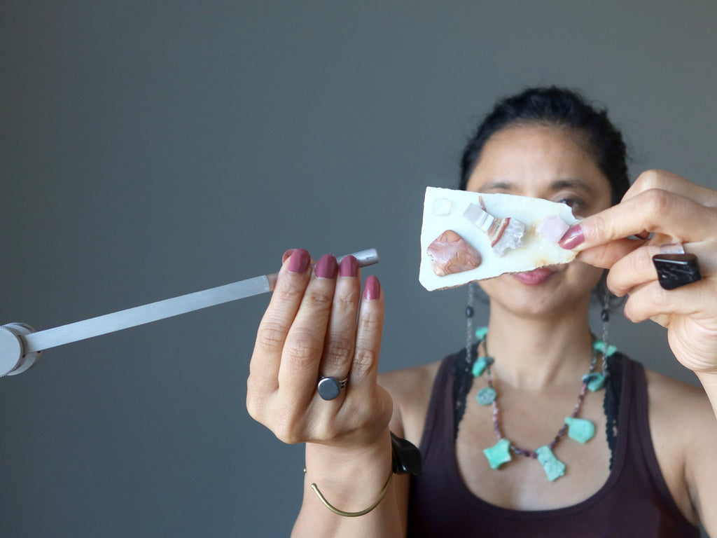 sheila of satin crystals holding a chakra plate and tuning fork