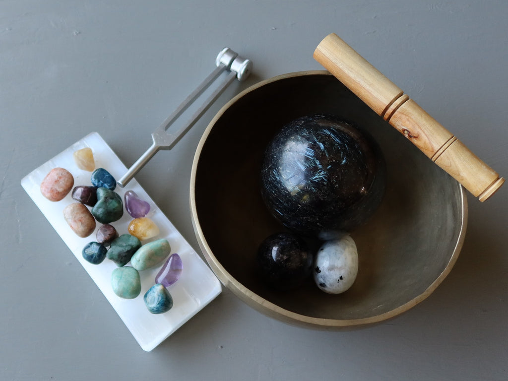 tuning fork, chakra set, singing bowl with crystals