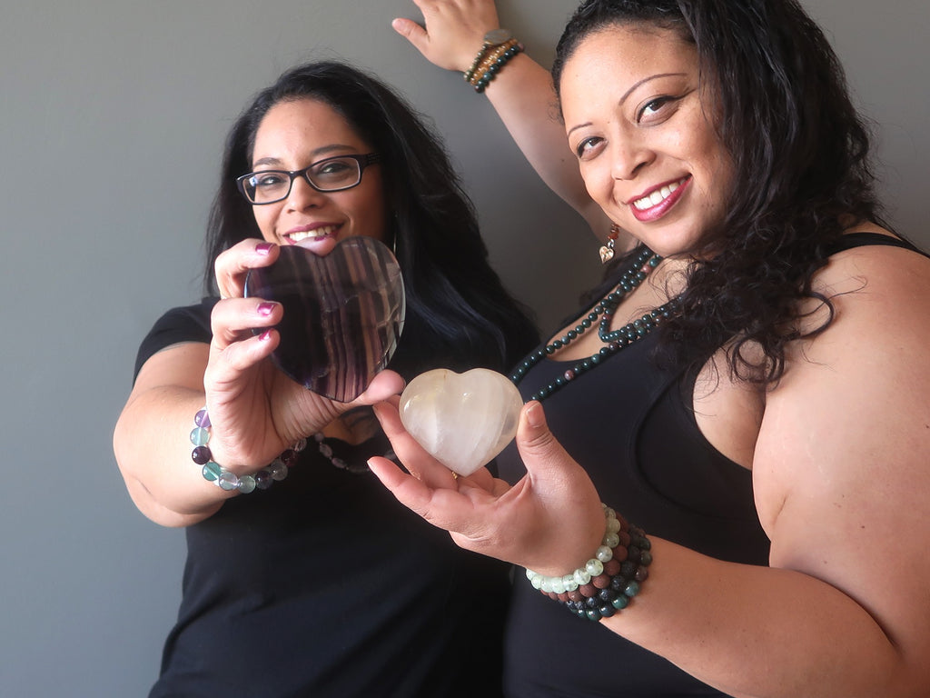 two women holding crystal hearts