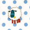 White, teal, yellow and red enamel on gold toned metal sheep pin on blue polka dot fabric project bag by Pretty Warm Designs