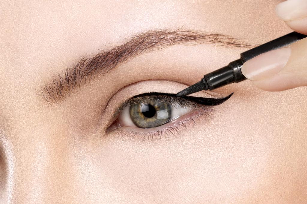 woman applies 2 in 1 lash adhesive glue eyeliner 