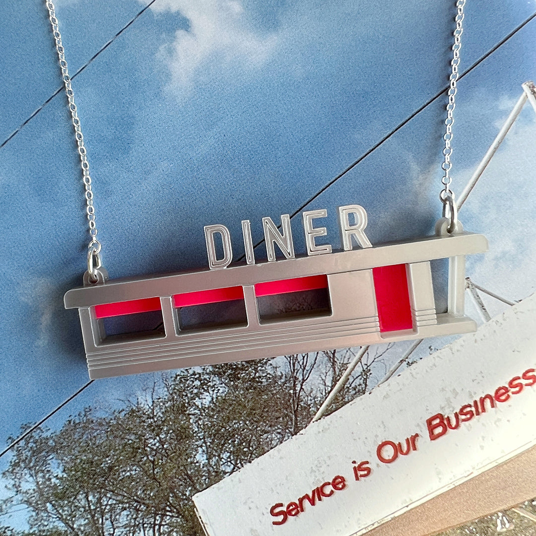 Laser cut acrylic necklace in the shape of an American diner