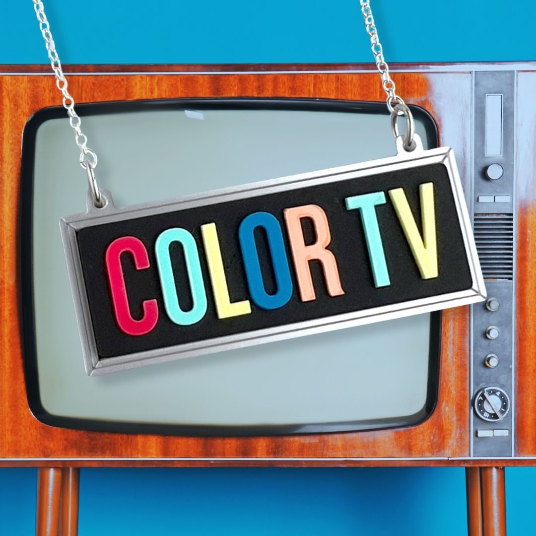 colourful typographic color tv sign necklace with an image of a vintage television in the background