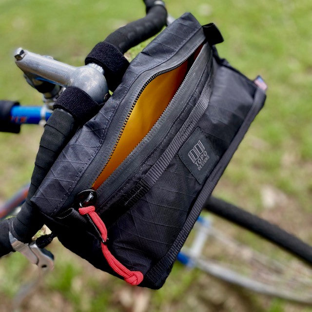 topo designs bike bag for handlebars with shoulder strap in yellow