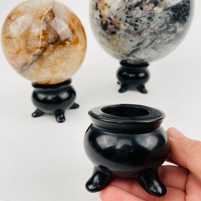 black obsidian sphere holder in hand for size reference 