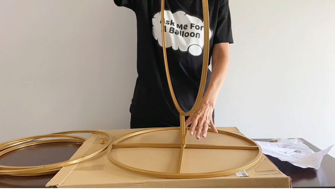 Person assembling a hoop stand