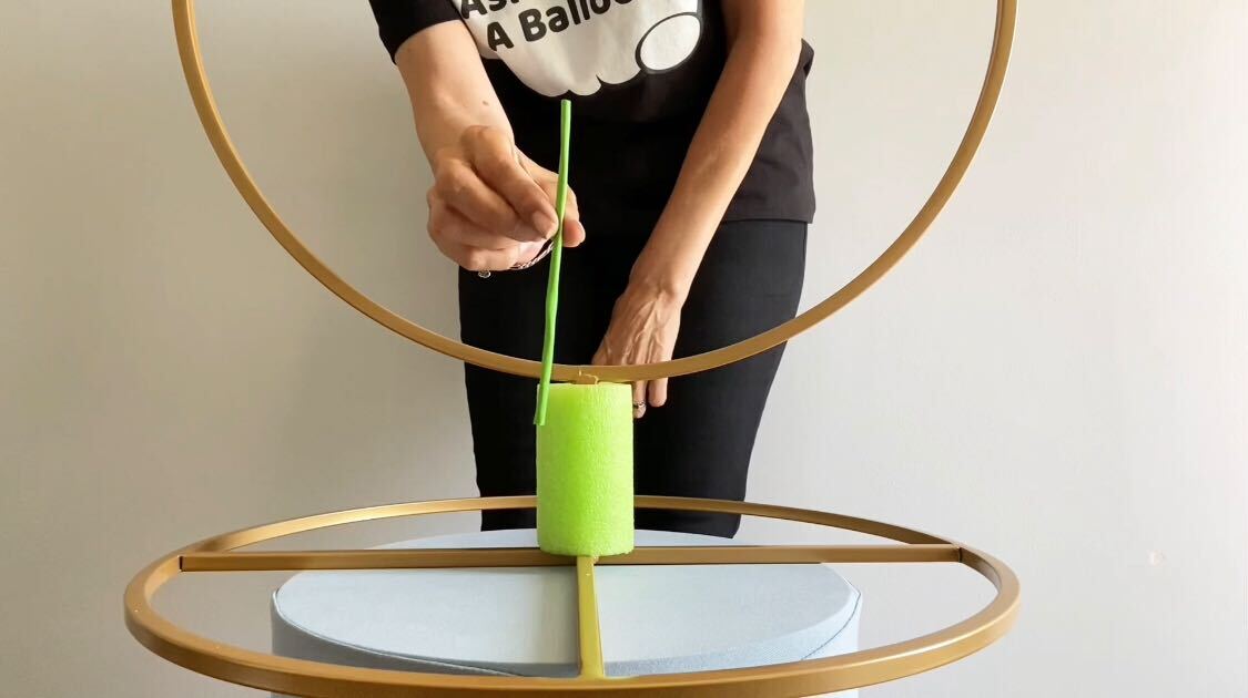 Person attaching styrofoam to the hoop stand