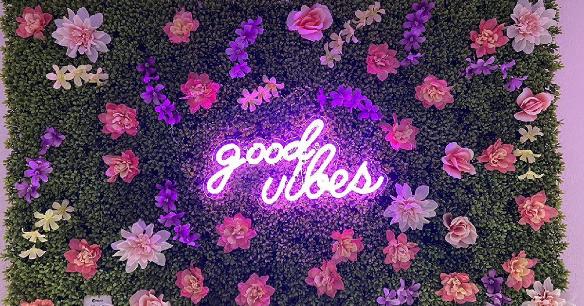 “Good vibes” neon amidst florals - best lights for party mood