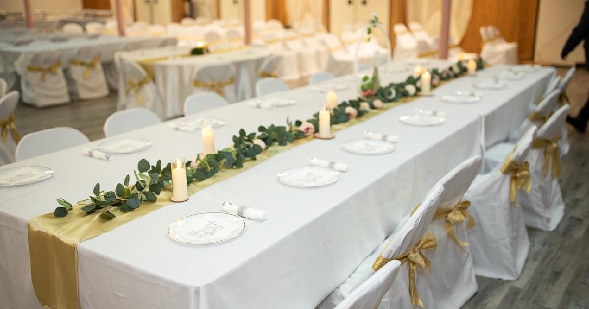 Elegant event table with golden runner, candles, and best lights for party