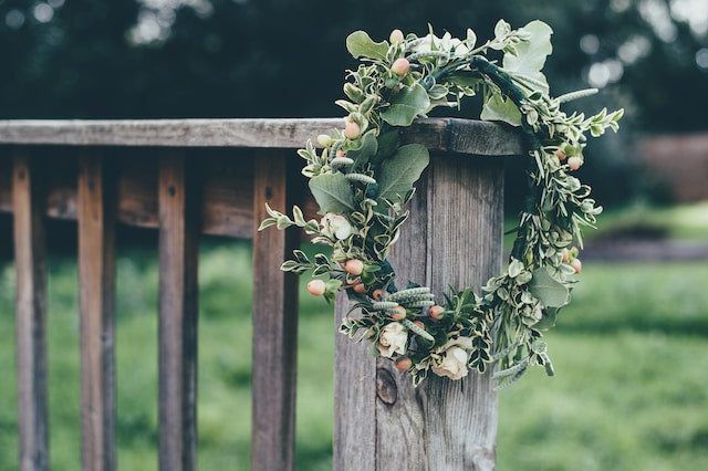 A green wreath with floral decor