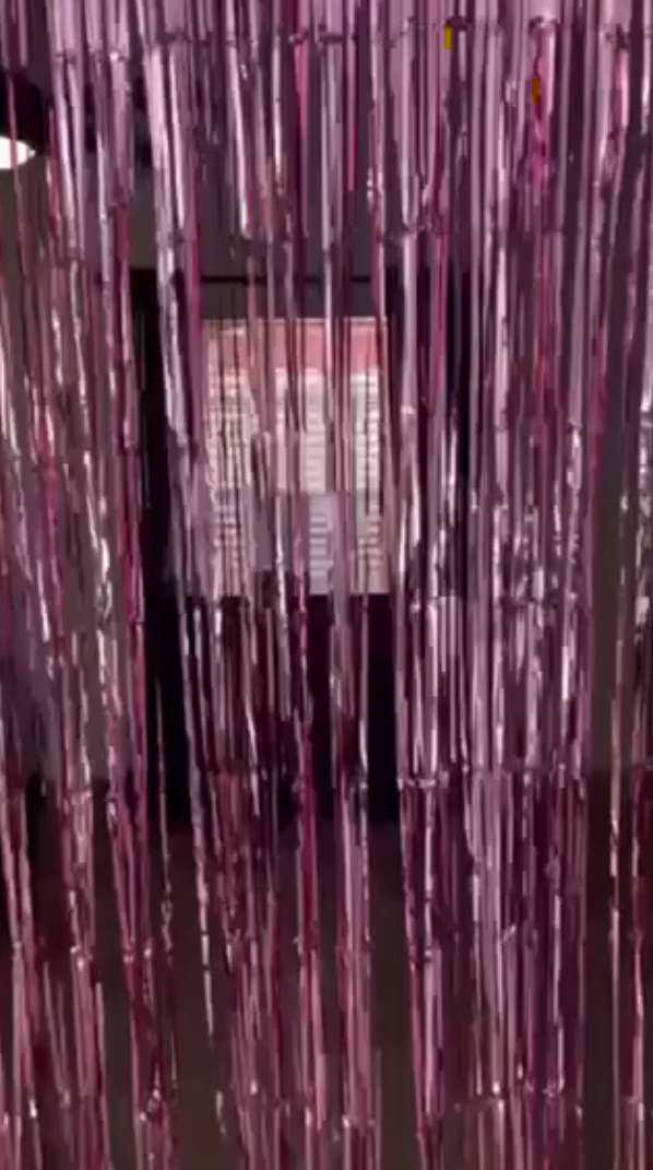 Metallic pink tinsel foil fringe backdrop