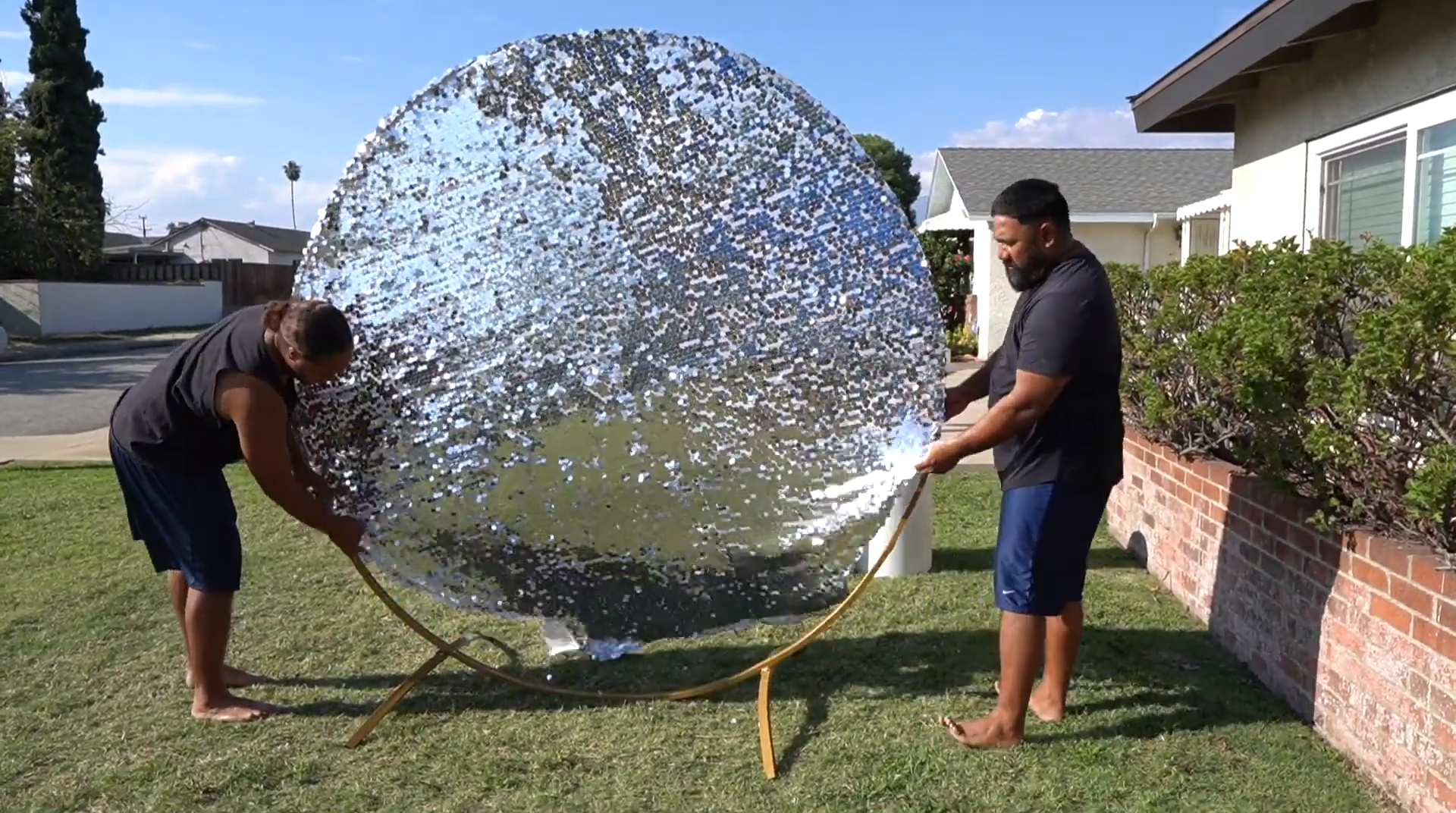 Person putting a sequin fitted cover on to the backdrop stand