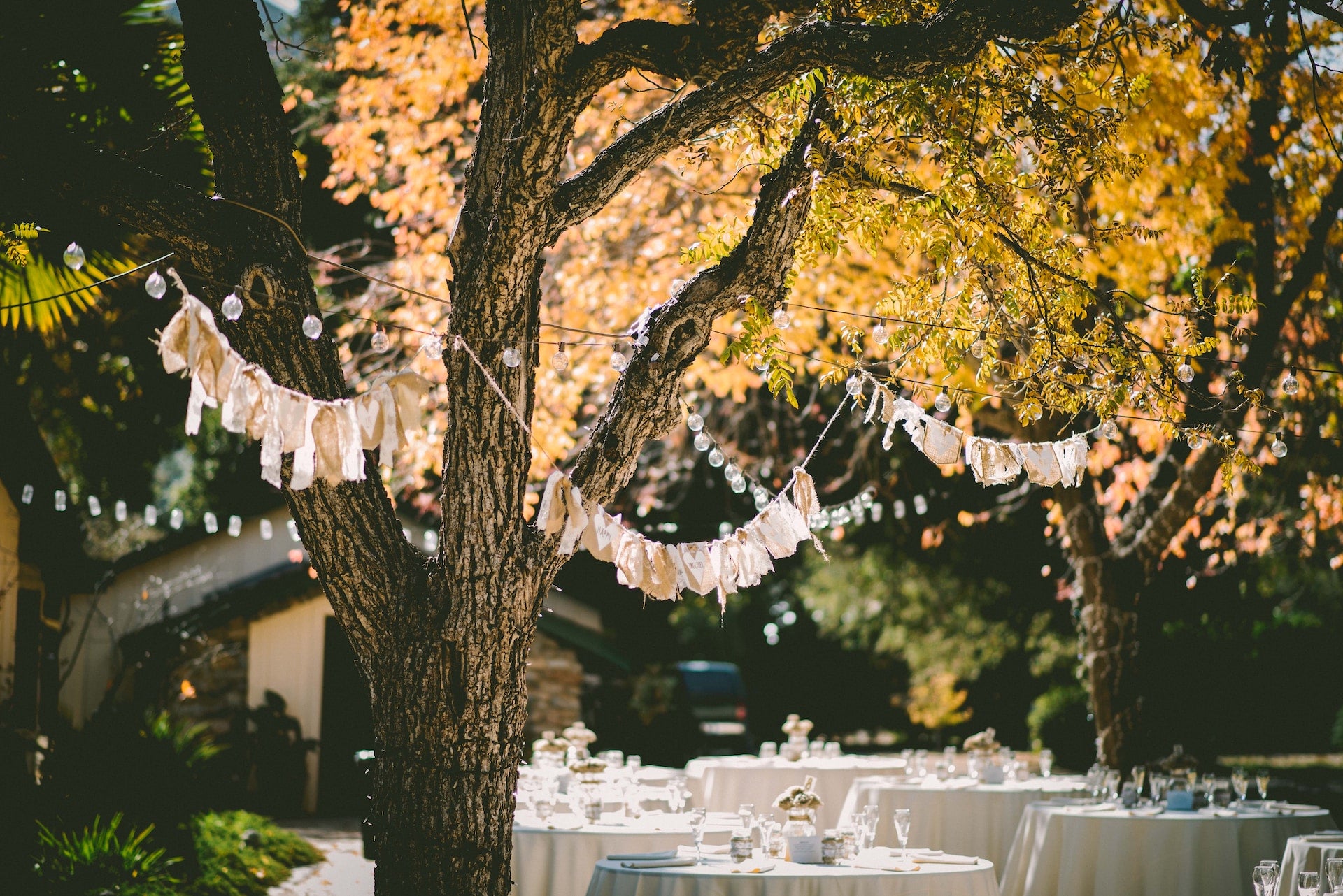 Outdoor wedding reception with hanging banners
