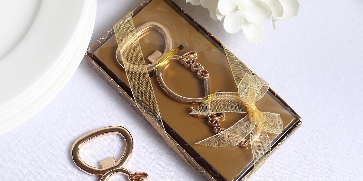 Bottle opener keychains in a gold box with golden ribbon for useful party favor ideas