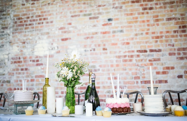 Candles and flowers in a glass vase